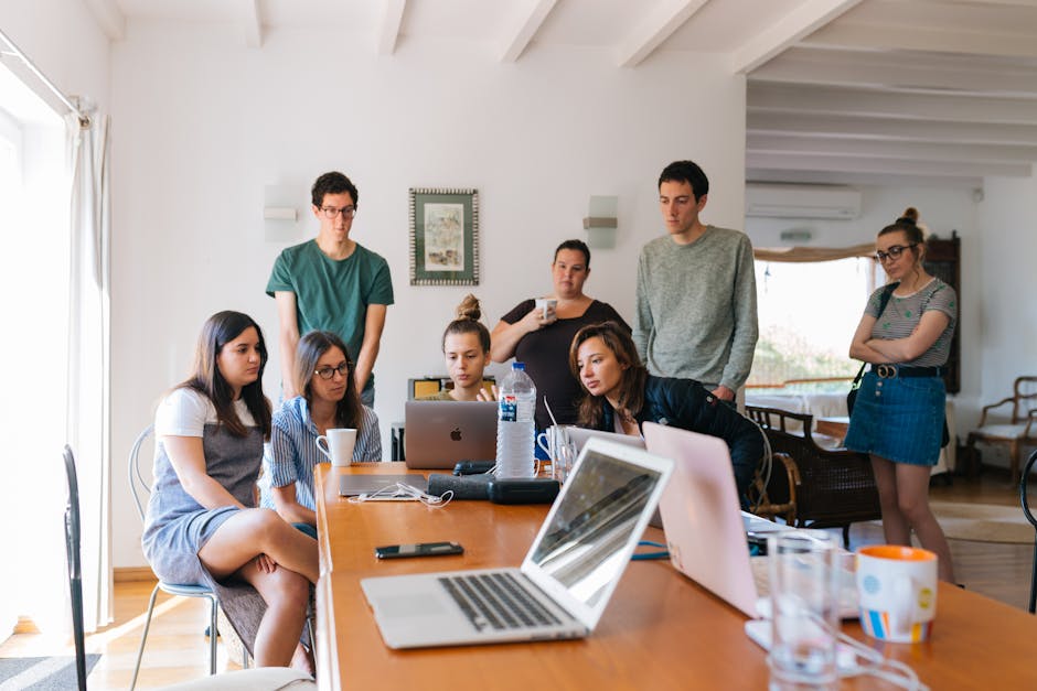 Group of young professionals engaged in a collaborative meeting in a modern office setting